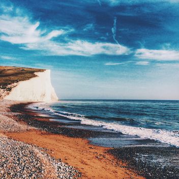 Sea and rocky coast under blue sky, England - Free image #183859