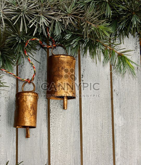 Christmas tree decoration,metal bells in the pine tree - image #183909 gratis