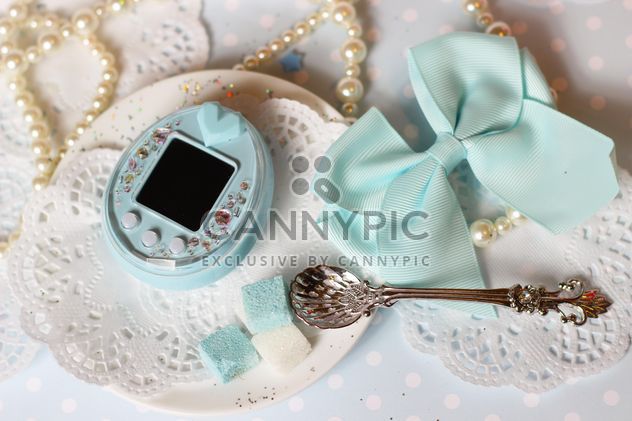 Tamagotchi and decorations on table - image #187659 gratis