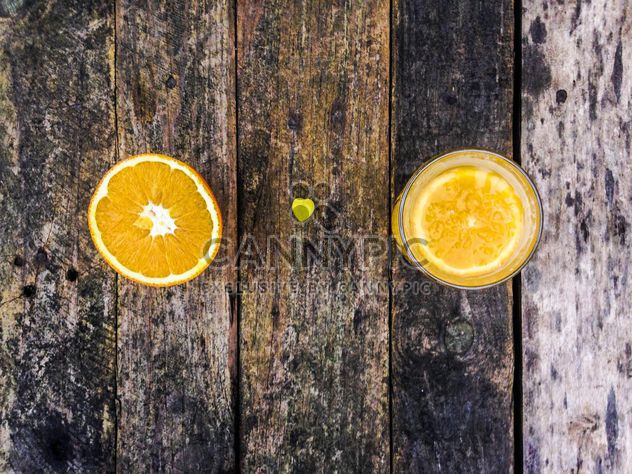 Orange juice on wooden table - Free image #198939