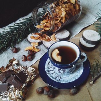 Cup of tea, dried apples and chocolate - бесплатный image #272249