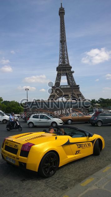 Yellow Rental Lamborghini in busy traffic near Eiffel Tower in Paris - бесплатный image #334229