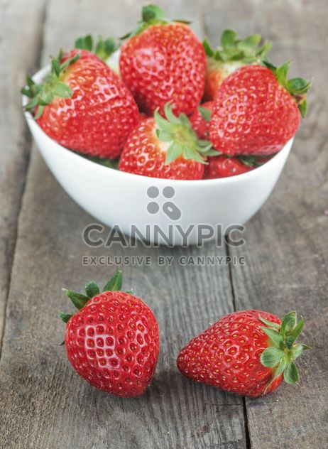 Small white china bowl filled with strawberries - image #334279 gratis
