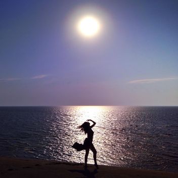 Girl on seashore at sunset - image #338479 gratis