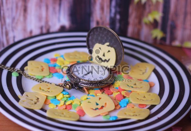 tiny halloween cookies on a plate with pocket watch - бесплатный image #342149