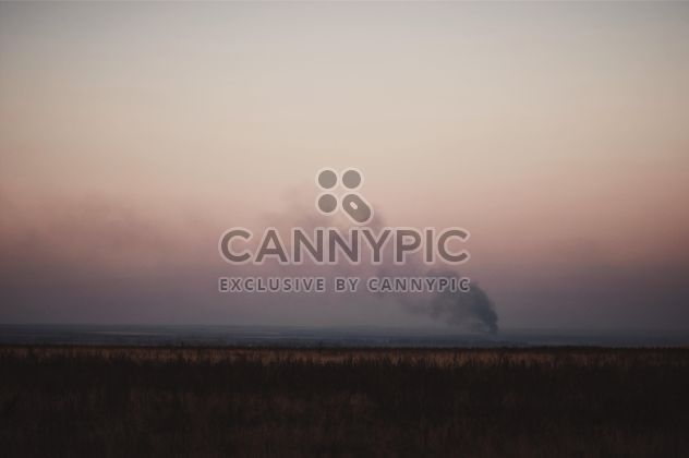 Landscape with smoke in field at sunset - image gratuit #346299 