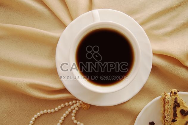 Cup of black coffee on beige cloth - бесплатный image #346929
