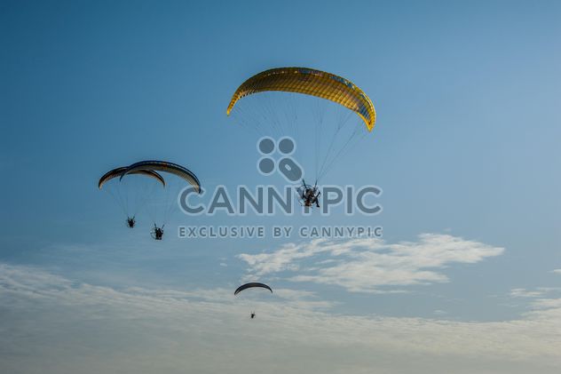 Paragliders flying in blue sky - Free image #347309