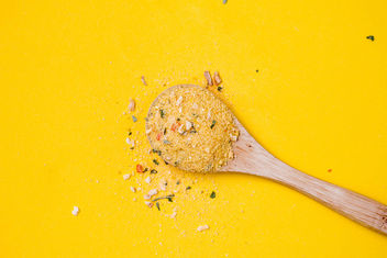 Top view of wooden spoon with yellow spice on yellow background - бесплатный image #448899
