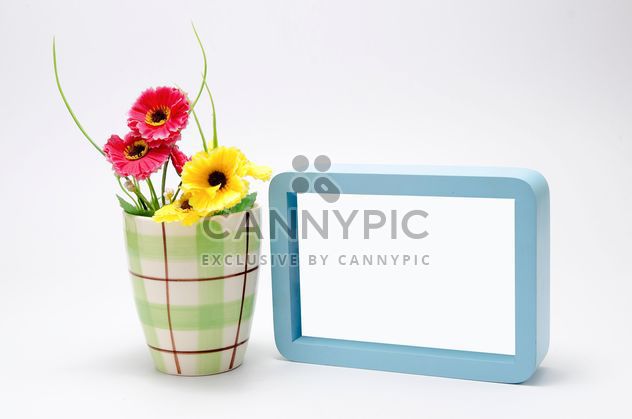 minimal still life : a cup with flowers and blue frame - image #452399 gratis