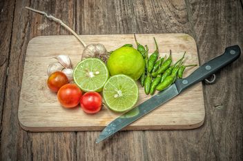 Lime, vegetables and knife on wooden cutting board - бесплатный image #452419