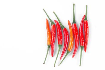 Red chili peppers on a white background - image gratuit #452609 