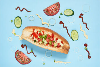 Tasty hotdog and ingredients on blue background - бесплатный image #480249