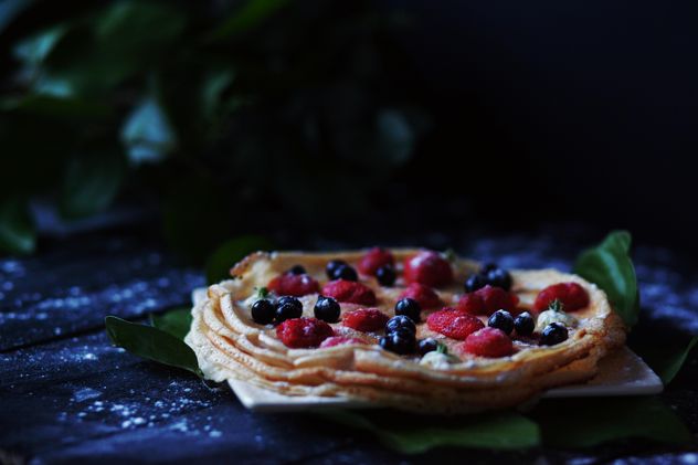Pancakes with berries on wooden background - image #136459 gratis