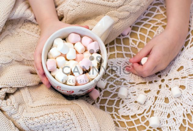 Cup of marshmallows in child's hand - Free image #182659