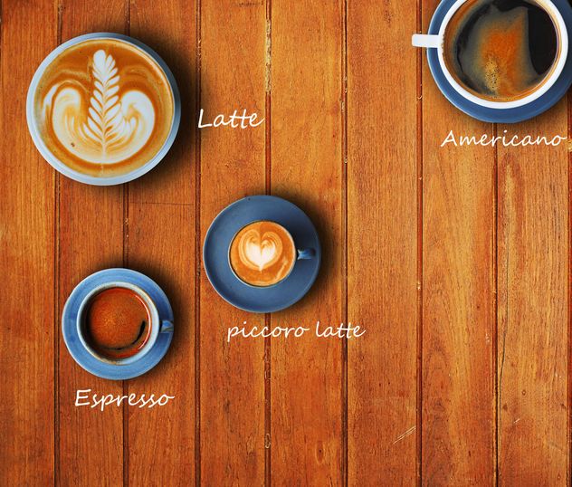 Cups of different coffee on wooden background - бесплатный image #186959