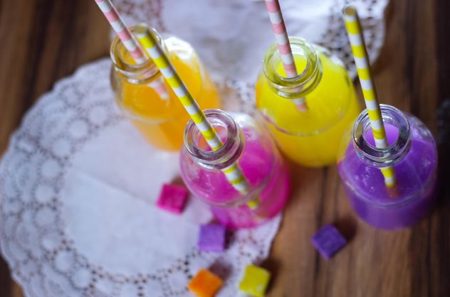 Bottles of colorful drinks - image #187619 gratis