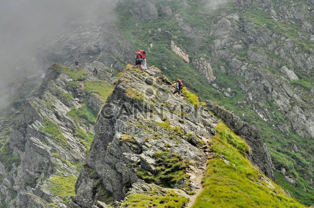Alpinist hiking on mountain peak - image #198159 gratis