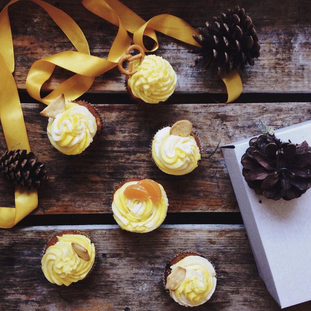 Christmas cupcakes, pine cones and ribbon - Free image #198459