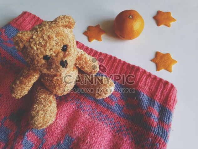 Children's sweater and a toy bear, tangerines on a white background - image #198789 gratis