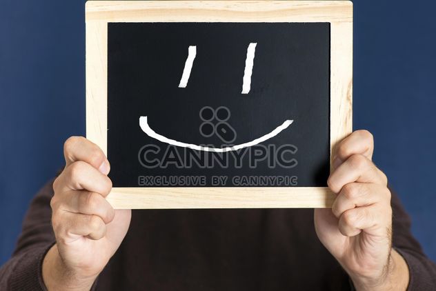 Man holding blackboard with happy smile in front of his face - image gratuit #271599 