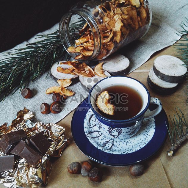 Cup of tea, dried apples and chocolate - бесплатный image #272249