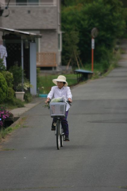 Old Japanese Woman enjoying riding her bicycle - бесплатный image #305739