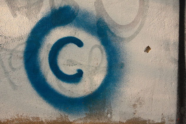 Large copyright graffiti sign on cream colored wall - image #313779 gratis