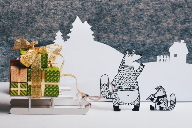 Paper foxes with gifts on sledge in winter - image #327309 gratis