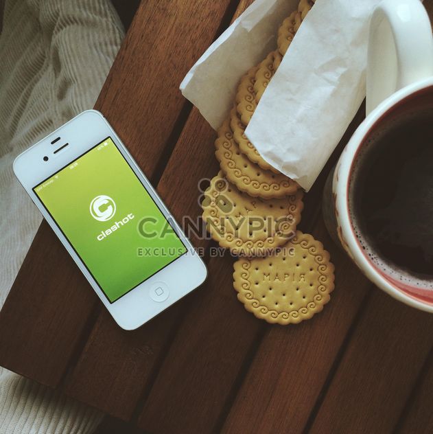 Breakfast with biscuits, cup of coffee and iPhone with Clashot logo - бесплатный image #329129
