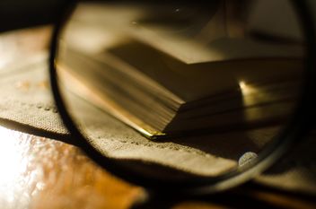 Autumn yellow leaves through a magnifying glass with incense sticks and book - image #330409 gratis