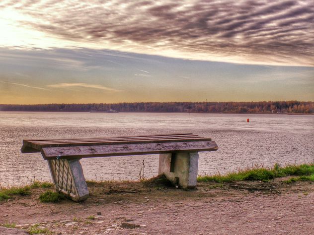 Bench on shore of lake at sunset - Free image #338559