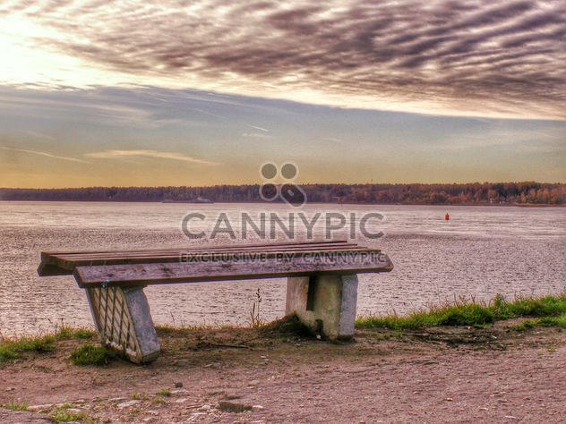 Bench on shore of lake at sunset - Free image #338559