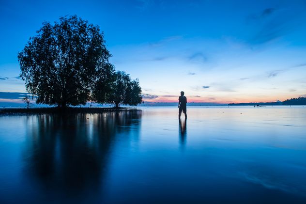 Man in sea at sunset - Free image #338579