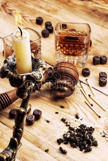Candlestick, smoking pipe and glass of cognac on wooden background - Kostenloses image #342899