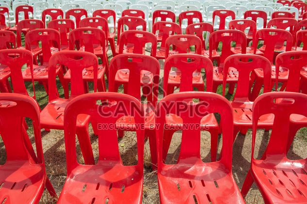 Red and white plastic chairs - image #344529 gratis