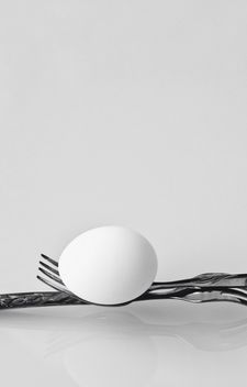 Chicken egg on forks on white background - бесплатный image #344599
