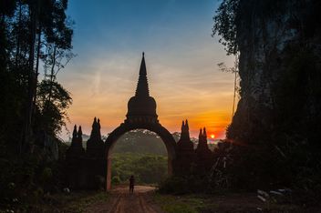 Man at gates to temple at sunset - Free image #344619