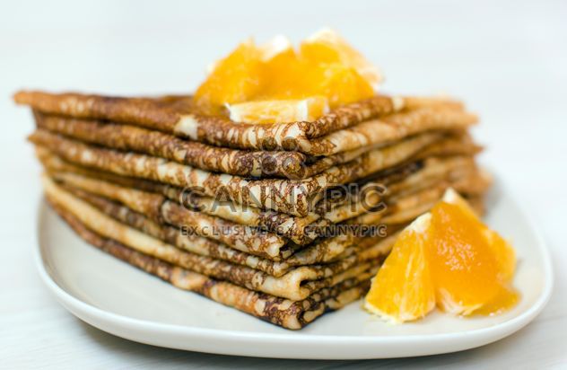 Closeup of pancakes with orange on plate - бесплатный image #345039