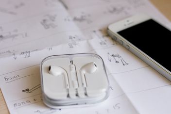 Closeup of smartphone and earphones on paper - image gratuit #345049 
