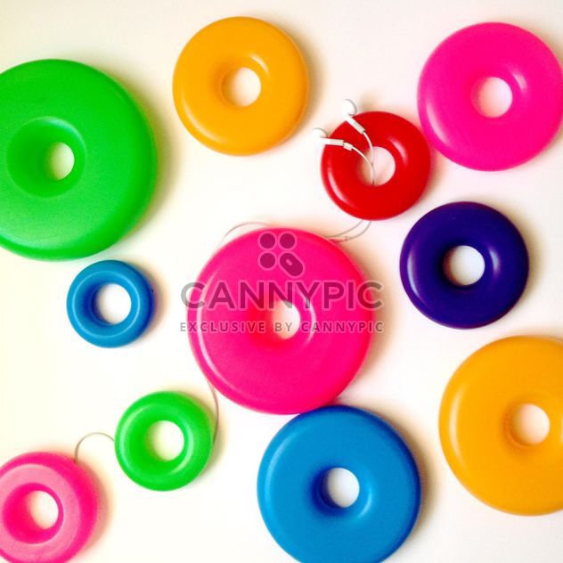 Earphones and colorful rings on white background - image #346559 gratis