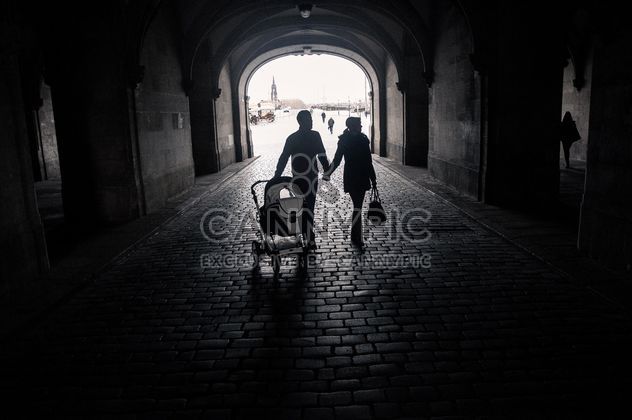 Happy family with baby walking in street, black and white - бесплатный image #346579