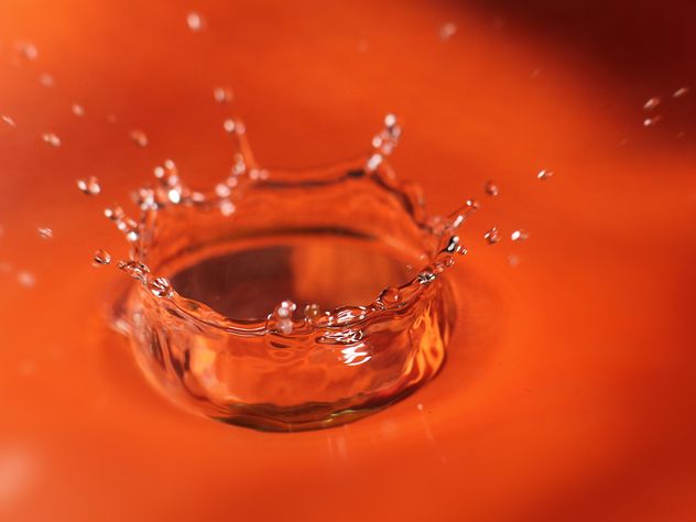 Closeup of water splash on orange background - image gratuit #347709 