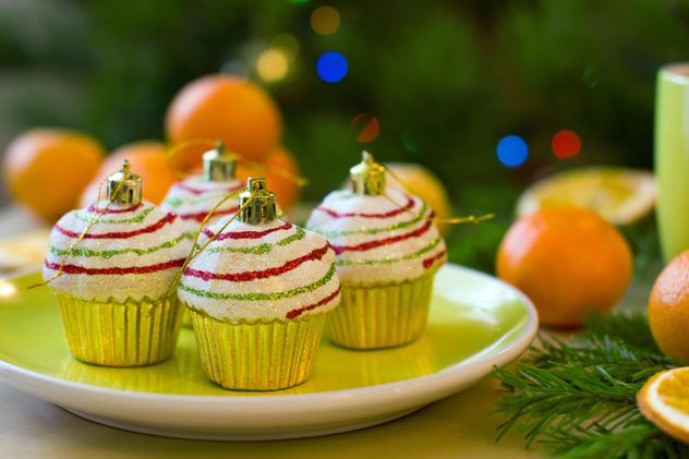 Christmas decorations in shape of cakes on plate - бесплатный image #347799