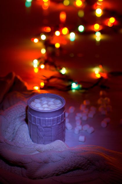 Cup of cocoa with marshmallows in light of garlands - Free image #347949