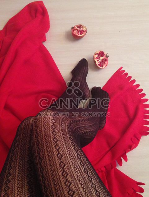 Female legs in black stockings, red blanket and pomegranate - Kostenloses image #347999
