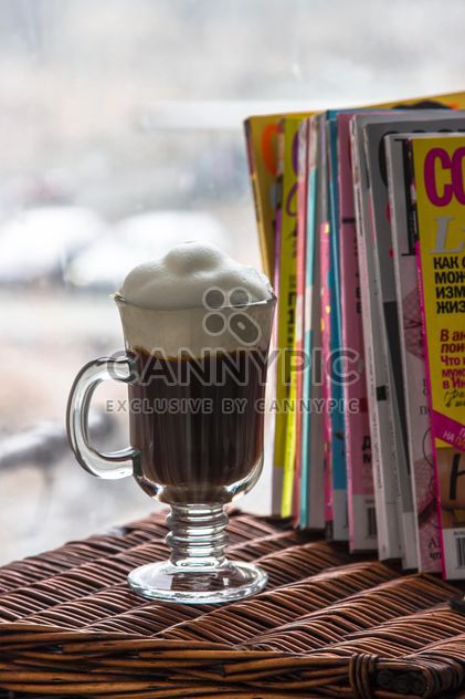 Cup of coffee and pile of magazines - image #350309 gratis