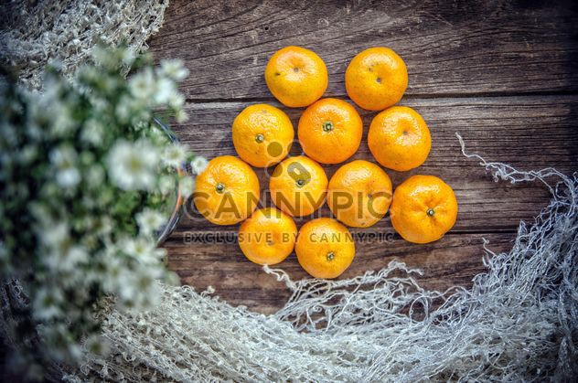 Tangerines on wooden background - бесплатный image #452499