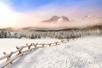 Fence leads through a snow field towards the Sawtooth Mountains - бесплатный image #467709