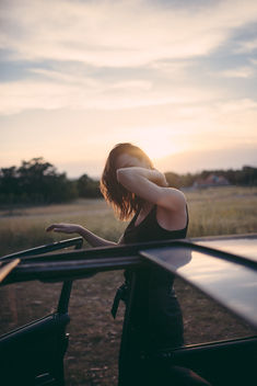 Hipster girl looking out from a vintage car during the sunset. - image gratuit #467839 